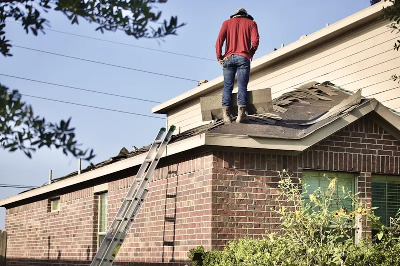 Professional roofer working on a residential roof in Kansas City